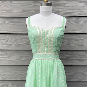 Mint Green Gunne Sax style dress made with vintage flocked dot fabric. Accented with lace and ribbon trim. Fully lined. Size 8