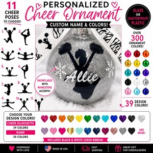May include: A silver glittery round ornament featuring a black silhouette of a cheerleader holding pom-poms, the name Allie in white script, and two snowflake accents with rhinestones. It includes a black and white patterned ribbon.