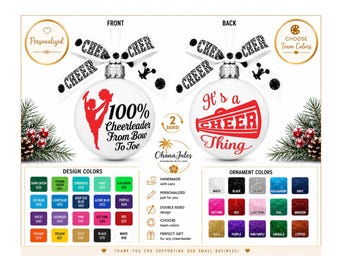 May include: A white round ornament with a red cheerleader silhouette and the text 100% Cheerleader From Bow To Toe on the front, and a red megaphone graphic with the text It's a CHEER Thing on the back, topped with a black and white cheer ribbon.