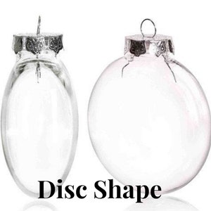 May include: Two clear glass disc-shaped ornaments with silver-colored metal caps and hanging loops. The text "Disc Shape" is printed in black at the bottom of the image. One ornament is oval, the other is round.