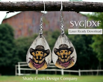 May include: A pair of laser cut wooden earrings featuring a golden retriever wearing a cowboy hat and bandana. The earrings are hanging from silver hooks and are in the shape of a teardrop. The text "SVG|DXF Laser Ready Download" is visible in the image.