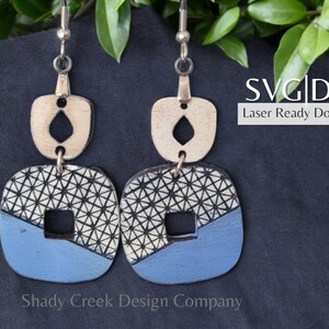 May include: A pair of blue and white geometric patterned earrings with a small white diamond shape cutout in the top piece. The earrings are hanging from silver hooks. SVG | DXF Laser Ready Download.