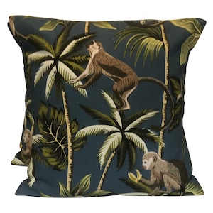 May include: A blue cushion with a tropical print featuring monkeys and palm trees.