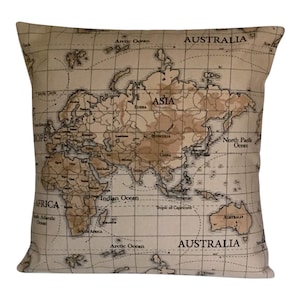 May include: A beige cushion with a vintage world map design. The map features continents in brown and black with ocean areas in white. The cushion has the words "Arctic Ocean", "ASIA", "AUSTRALIA", "North Pacific Ocean", "Indian Ocean", "AFRICA", "South Atlantic Ocean", and "Tropic of Capricorn" printed on it.