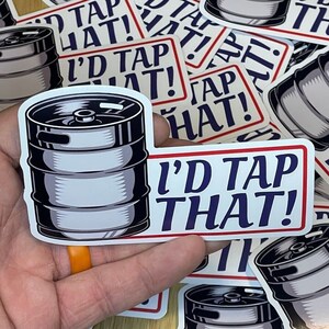 May include: A set of stickers featuring a silver keg with the text "I'd Tap That!" in blue and red lettering.