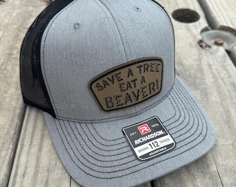 Save A Tree, Eat A Beaver leather patch hat - funny and cool cap! Hats make a great gift! Comes with a FREE matching sticker!
