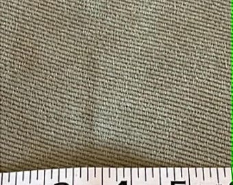 Pea green upholstery fabric with a twill weave and a corduroy feel.  Sold by the half yard.