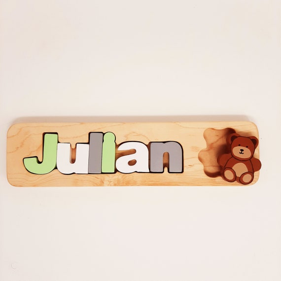 Each letter is a hand-cut maple wood puzzle piece shaped to the child's name — a tactile, heirloom-quality keepsake a real woodworker made.