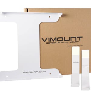 May include: White wall mount for a gaming console with the text "VIMOUNT Console Wall Mount" and the website address "www.vimount.com" printed on the packaging.