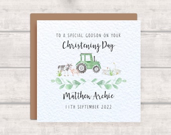 May include: A green tractor with a cow, pig, and two geese on a white card with the text "To a special godson on your Christening Day", "Matthew Archie", and "11th September 2022".