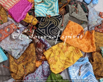 May include: A collection of colorful fabric drawstring pouches with various patterns and designs. The pouches are made of silk and are perfect for storing small items.