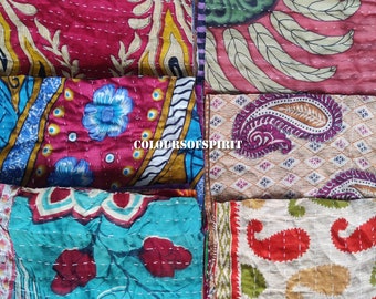 May include: A collection of ten colorful fabric squares with various patterns, including floral, paisley, and geometric designs. The fabric squares are all stitched together with white thread.