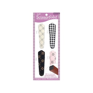 May include: A package of designer scissor sheaths with various patterns. The sheaths include designs like a black and white houndstooth, a cream diamond pattern, a black floral pattern, and a pink chain pattern. The package also includes the text "Scissorfobz".