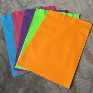 May include: Five colorful mailing envelopes in various shades of blue, pink, purple, green, and orange.
