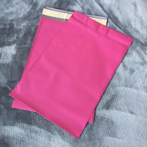 May include: Two pink mailing envelopes with a white and gray adhesive strip.