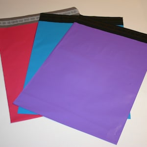 May include: Three mailing envelopes in different colors: red, blue, and purple. The envelopes have a black border and a white stripe along the top.