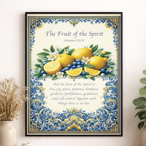 May include: Framed art print featuring the text "The Fruit of the Spirit" with Galatians 5:22-23. The image includes lemons, blueberries, and white flowers. The border is blue and gold with ornate patterns. The text "But the fruit of the Spirit is..." is also included.