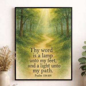 May include: Framed art print with a watercolour painting of a forest path illuminated by sunlight. The artwork includes the text "Thy word is a lamp unto my feet, and a light unto my path. Psalm 119:105."