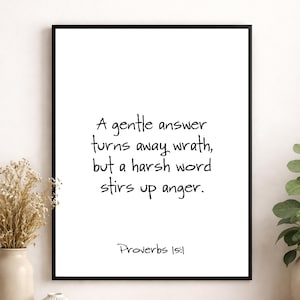 May include: A framed print with a black border displays the quote, "A gentle answer turns away wrath, but a harsh word stirs up anger." The text is in a handwritten style, with "Proverbs 15:1" at the bottom.