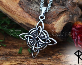 May include: A silver Celtic knot pendant necklace with a four-pointed star design. The pendant is on a silver chain and is resting on a piece of wood.