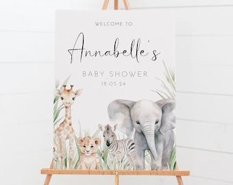 May include: Welcome to Annabelle's Baby Shower sign with a watercolor illustration of a giraffe, lion, zebra, and elephant. The sign is on a wooden easel.