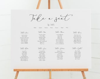 Puede incluir: Un diagrama de asientos blanco con el texto "Take a seat" en la parte superior. El diagrama está dividido en mesas con nombres como "Table One", "Table Two", etc. Cada mesa enumera los nombres de los invitados.