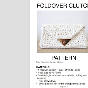 May include: A white crocheted foldover clutch with a gold triangle lock closure. The pattern includes instructions for making the clutch using a 400 gram bobbin of white t-shirt yarn and a 10mm crochet hook.