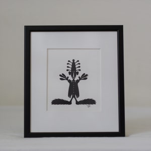 Frammed paper cut being. Made by danish paper cut artist Torben Jarlstrøm Clausen