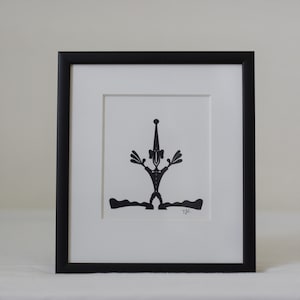 Frammed paper cut being. Made by danish paper cut artist Torben Jarlstrøm Clausen