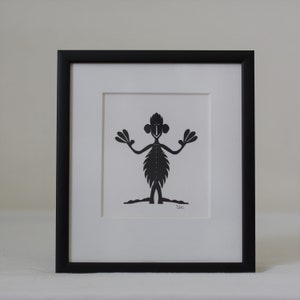 Frammed paper cut being. Made by danish paper cut artist Torben Jarlstrøm Clausen