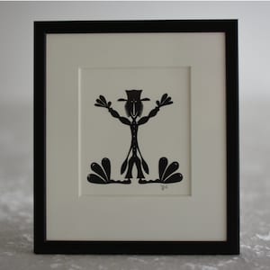 Frammed paper cut being. Made by danish paper cut artist Torben Jarlstrøm Clausen