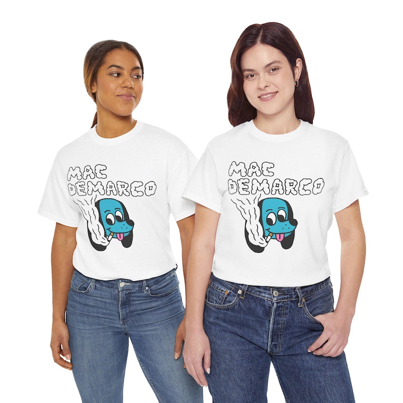 May include: Two people wearing white t-shirts with a blue dog graphic and the text "MAC DEMARCO". The people are wearing blue jeans.