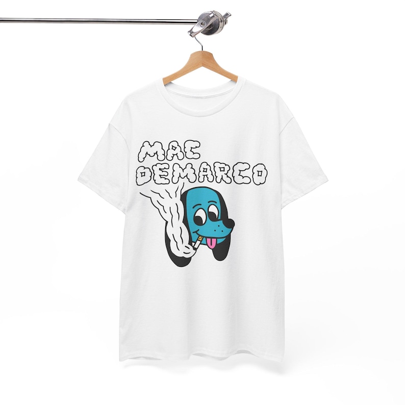 May include: White t-shirt with a blue cartoon dog smoking a cigarette and the text "MAC DEMARCO" in black.