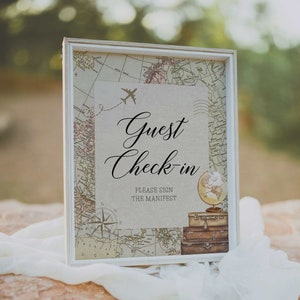 Puede incluir: Un letrero enmarcado con un diseño de mapa vintage, con las palabras "Guest Check-in" en escritura elegante. El letrero incluye un gráfico de avión y un globo, con una pila de maletas, perfecto para un evento temático de viajes.