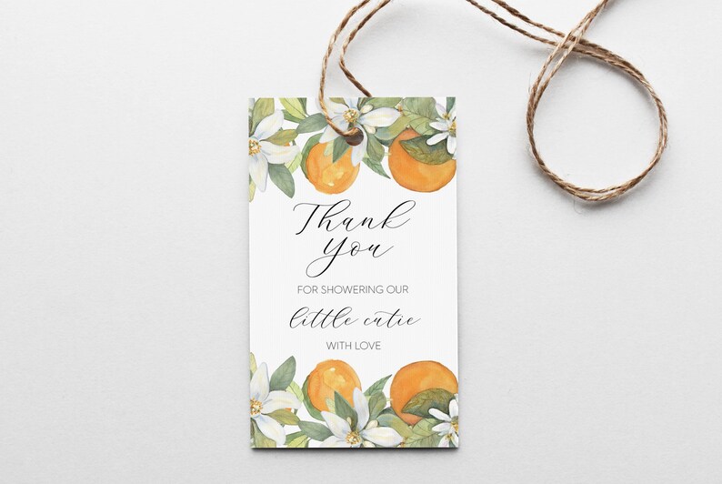 May include: White thank you tag with orange blossoms and oranges. The text reads "Thank you for showering our little cutie with love."