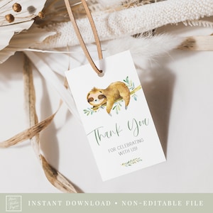 May include: A white thank you tag with a green leafy branch and a brown sloth sleeping on it. The text on the tag reads "Thank You" and "For Celebrating With Us!"