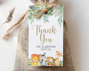 May include: Thank you for celebrating with us! A white card with gold lettering and a green leafy border. The card features a watercolour illustration of a lion, zebra, monkey, and giraffe.