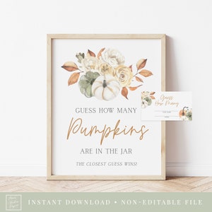 Könnte beinhalten: Ein druckbares Schild mit einer Aquarell-Illustration von Kürbissen, Blumen und Blättern. Das Schild lautet "Erraten Sie, wie viele Kürbisse im Glas sind. Die Person mit der besten Schätzung gewinnt!" Es gibt eine kleinere Karte, auf der "Erraten Sie, wie viele" steht, mit Platz für einen Namen und eine Schätzung.