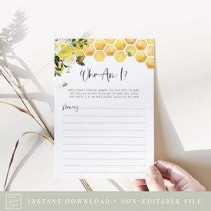May include: A white card with the text "Who Am I?" and lined spaces for writing. The card features a watercolor design of yellow flowers, a honeycomb pattern, and a bee. The text "INSTANT DOWNLOAD • NON-EDITABLE FILE" is at the bottom.