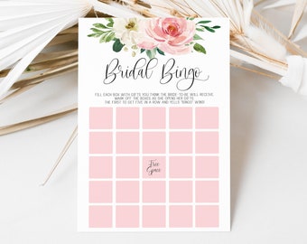 May include: A pink and white floral bridal shower bingo card with the text "Bridal Bingo" and instructions to fill each box with gifts the bride-to-be will receive. The first person to get five in a row and yell "Bingo" wins.