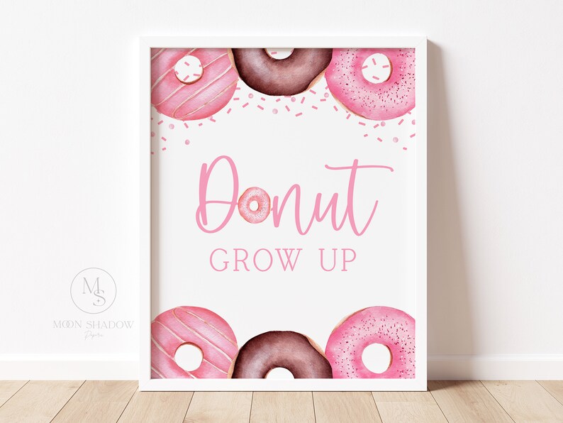 May include: Pink and brown donut-shaped illustrations with pink sprinkles and the text "Donut Grow Up" on a white background.