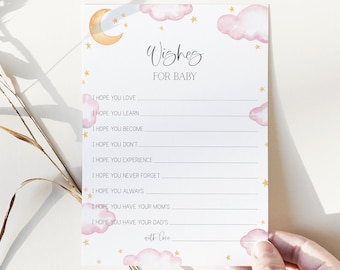 May include: A white card with a pink and gold watercolor design of clouds and stars. The card has the text "Wishes for Baby" and a list of prompts for writing wishes for a new baby.