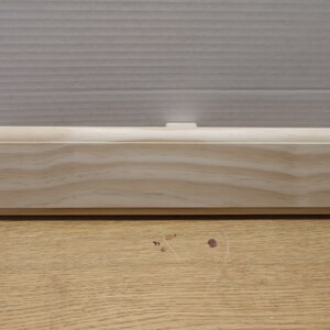 May include: A plain, unfinished wooden plaque with a slightly rounded edge. The plaque is made of light-colored wood with a natural grain pattern.