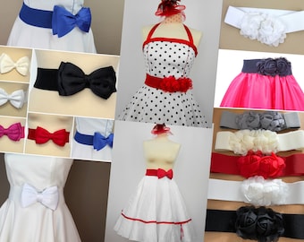 Könnte beinhalten: Eine Sammlung von Gummibändern mit verschiedenen Schleifen- und Blumenverzierungen. Die Gürtel sind in Schwarz, Weiß, Rot, Blau und Grau erhältlich.