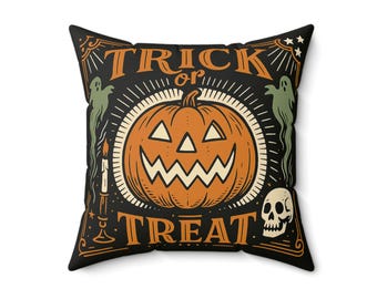 May include: Square Halloween-themed pillow with a black background and orange and white graphics. The design features a jack-o'-lantern, ghosts, a skull, and the words "TRICK or TREAT" in orange lettering. The pillow is a decorative item.