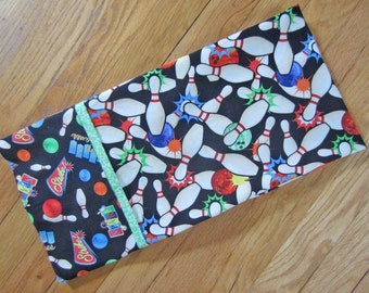 Bowling bonanza! Cotton standard/queen pillowcase with colorful tossed bowling pins and accessories. Dream those strikes!