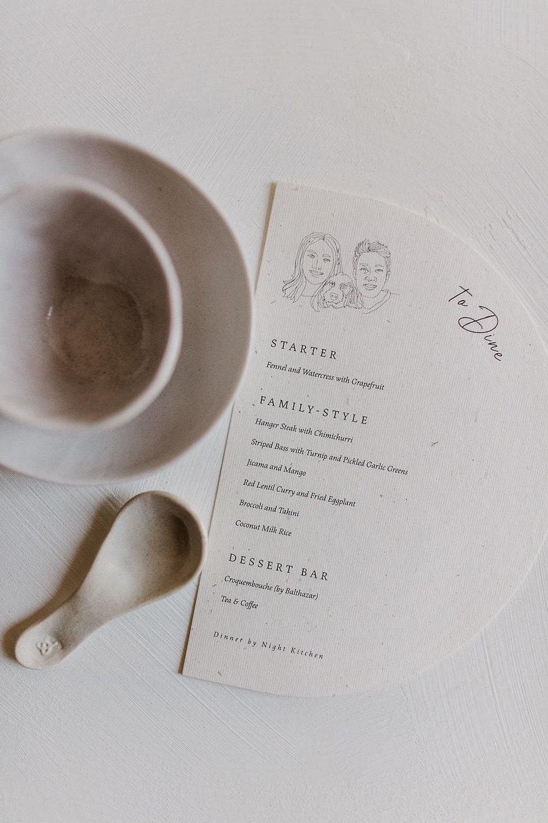 May include: A simple, elegant menu for a dinner party with a hand-drawn illustration of a couple and their dog. The menu features a starter, family-style dishes, and a dessert bar. The text reads "To Dine", "Starter", "Family-Style", "Dessert Bar", "Dinner by Night Kitchen", "Fennel and Watercress with Grapefruit", "Hanger Steak with Chimichurri", "Striped Bass with Turnip and Pickled Garlic Greens", "Jicama and Mango", "Red Lentil Curry and Fried Eggplant", "Broccoli and Tahini", "Coconut Milk Rice", "Croquembouche (by Balthazar)", "Tea & Coffee".