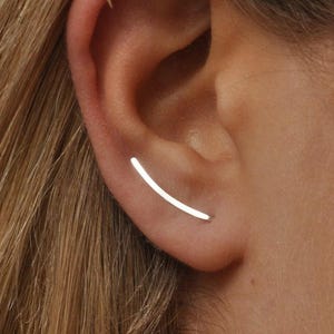 Smooth silver ear climber earring worn on ear, thin curved design for pierced ear