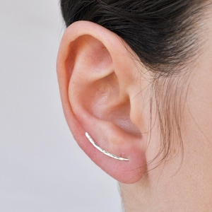 Hammered silver ear climber earring worn on ear, thin curved design for pierced ear