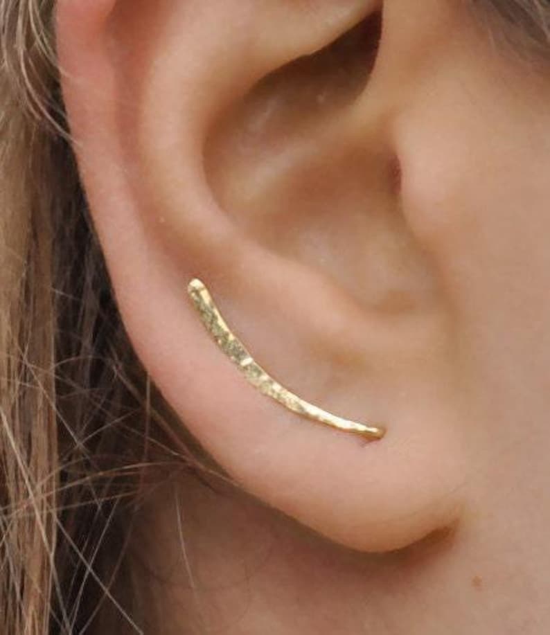 Hammered gold ear climber earring worn on ear, thin curved design for pierced ear